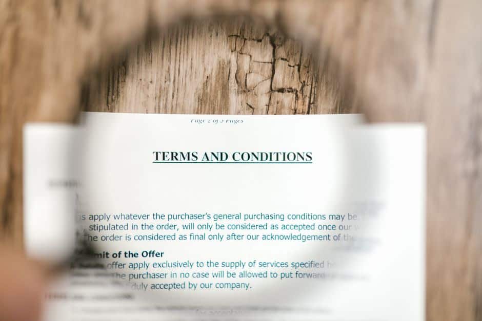 business contract document magnifying glass hidden details